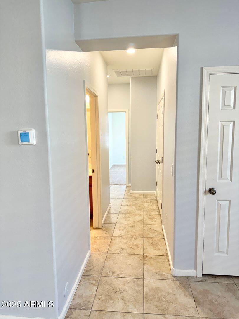 3870 East Balsam Drive Chandler, AZ 85286 - Photo 32 of 39 a view of a hallway with a dining area and a bathroom