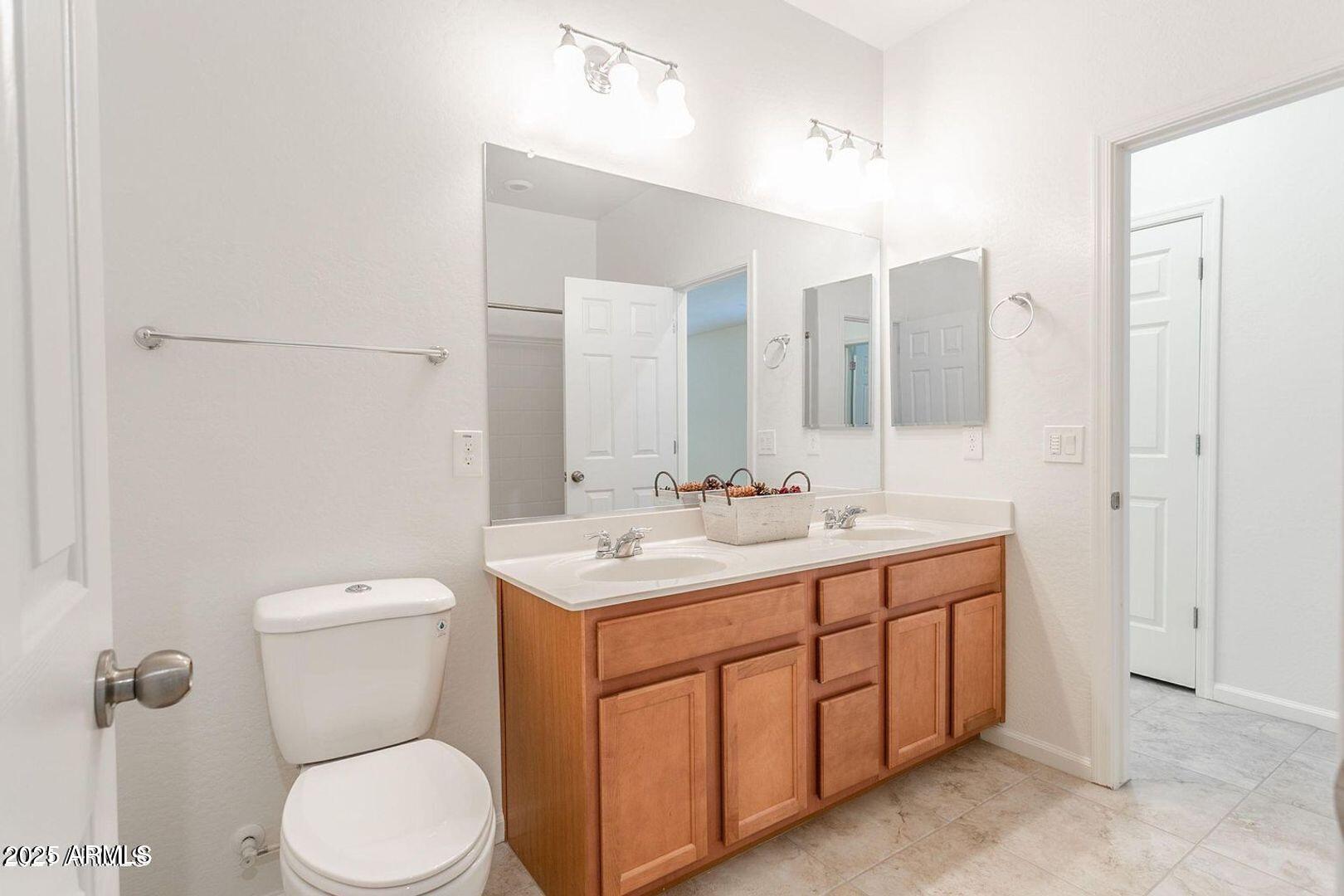 3870 East Balsam Drive Chandler, AZ 85286 - Photo 33 of 39 a bathroom with a toilet a sink and mirror