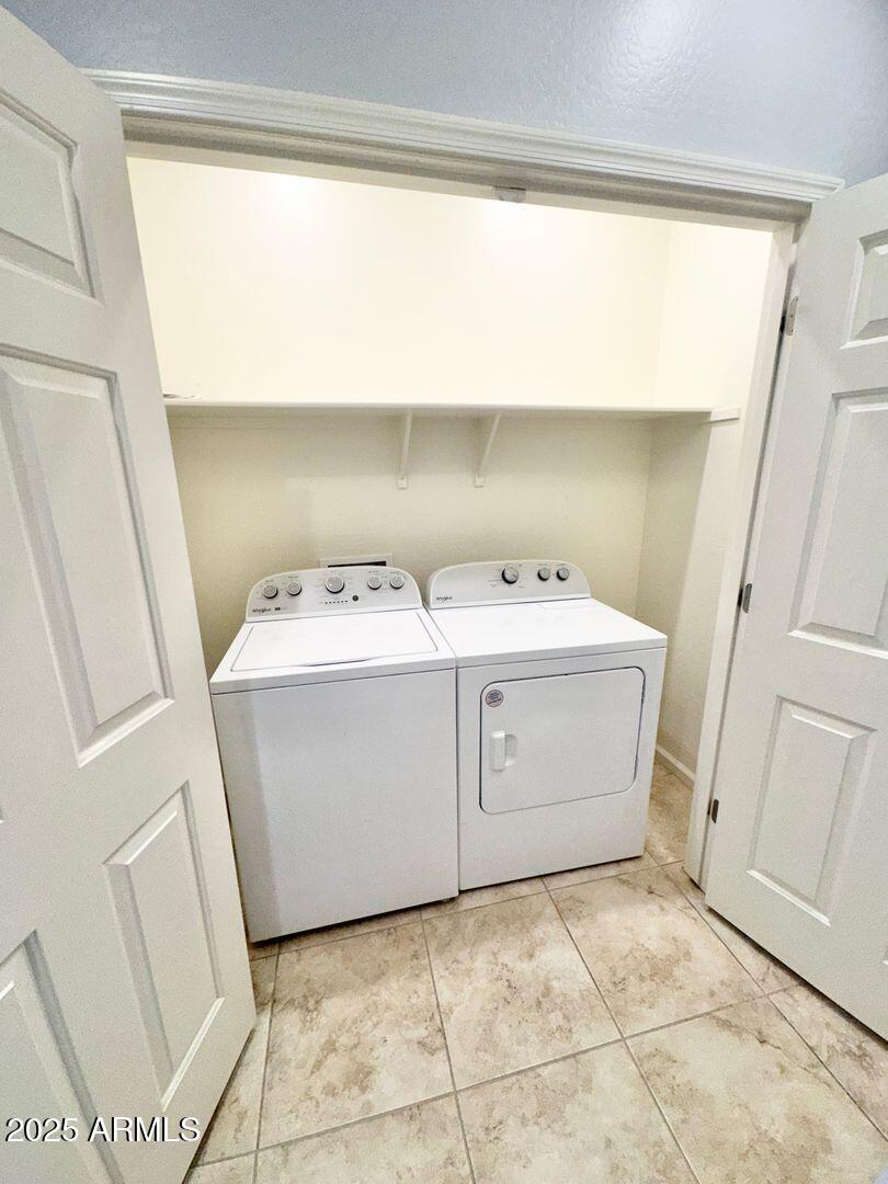 3870 East Balsam Drive Chandler, AZ 85286 - Photo 34 of 39 a utility room with a washer dryer and white cabinets