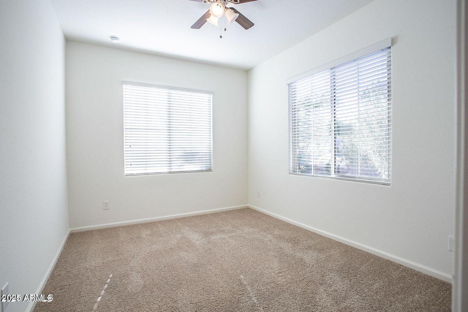3870 East Balsam Drive Chandler, AZ 85286 - Photo 35 of 39 an empty room with a window and a fan