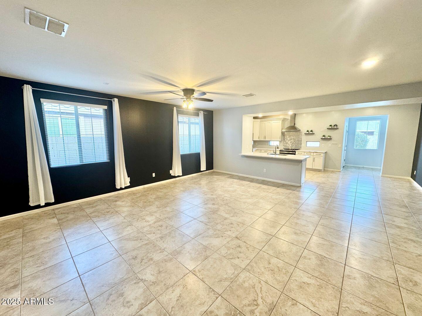3870 East Balsam Drive Chandler, AZ 85286 - Photo 5 of 39 a large white kitchen with granite countertop a sink and dishwasher a stove with wooden floor