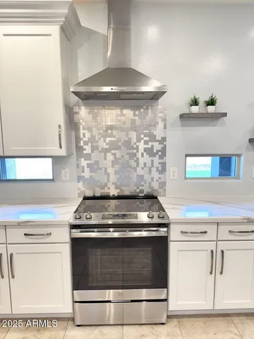 a stove top oven sitting inside of a kitchen
