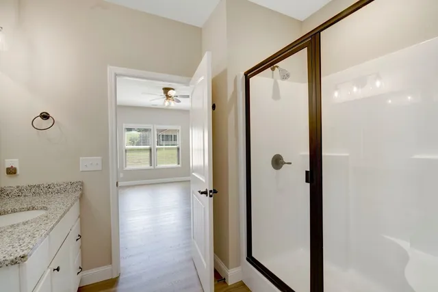 a bathroom with a granite countertop shower mirror and a sink