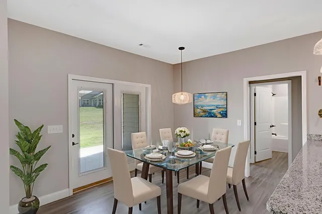 a view of a dining room with furniture window and wooden floor
