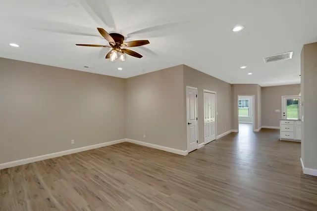 wooden floor in an empty room with a window
