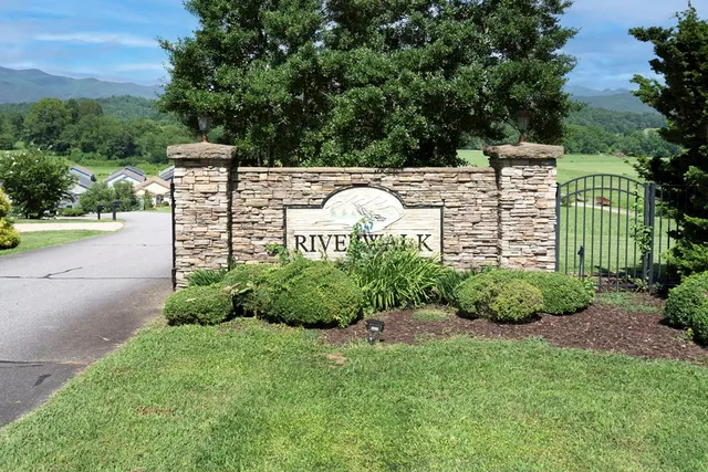 a view of a street with a houses in the background