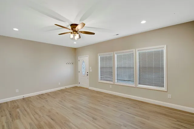 wooden floor in an empty room with a window