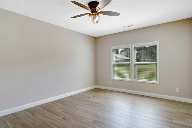 a view of a livingroom with a window and wooden floor