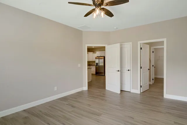 a view of an empty room and wooden floor