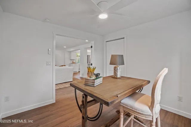 a view of a dining room with furniture and wooden floor