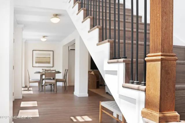 a view of entryway and hall with wooden floor