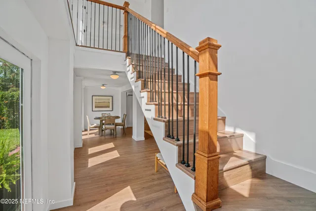 a view of entryway and hall with wooden floor