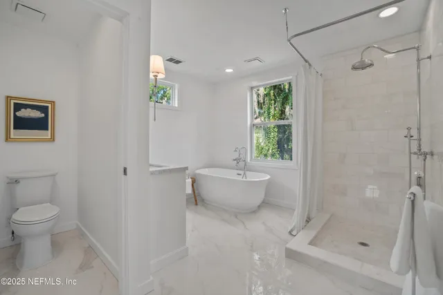 a bathroom with a bathtub and toilet