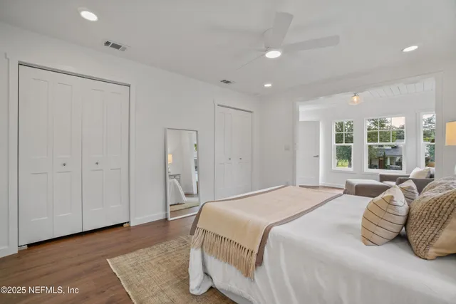 a spacious bedroom with a bed and a large window