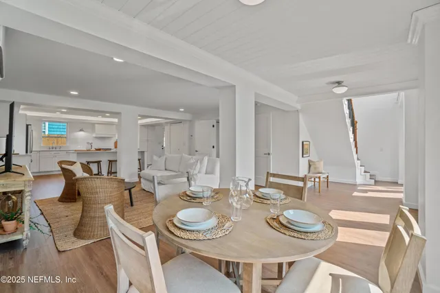 a dining room with furniture and wooden floor