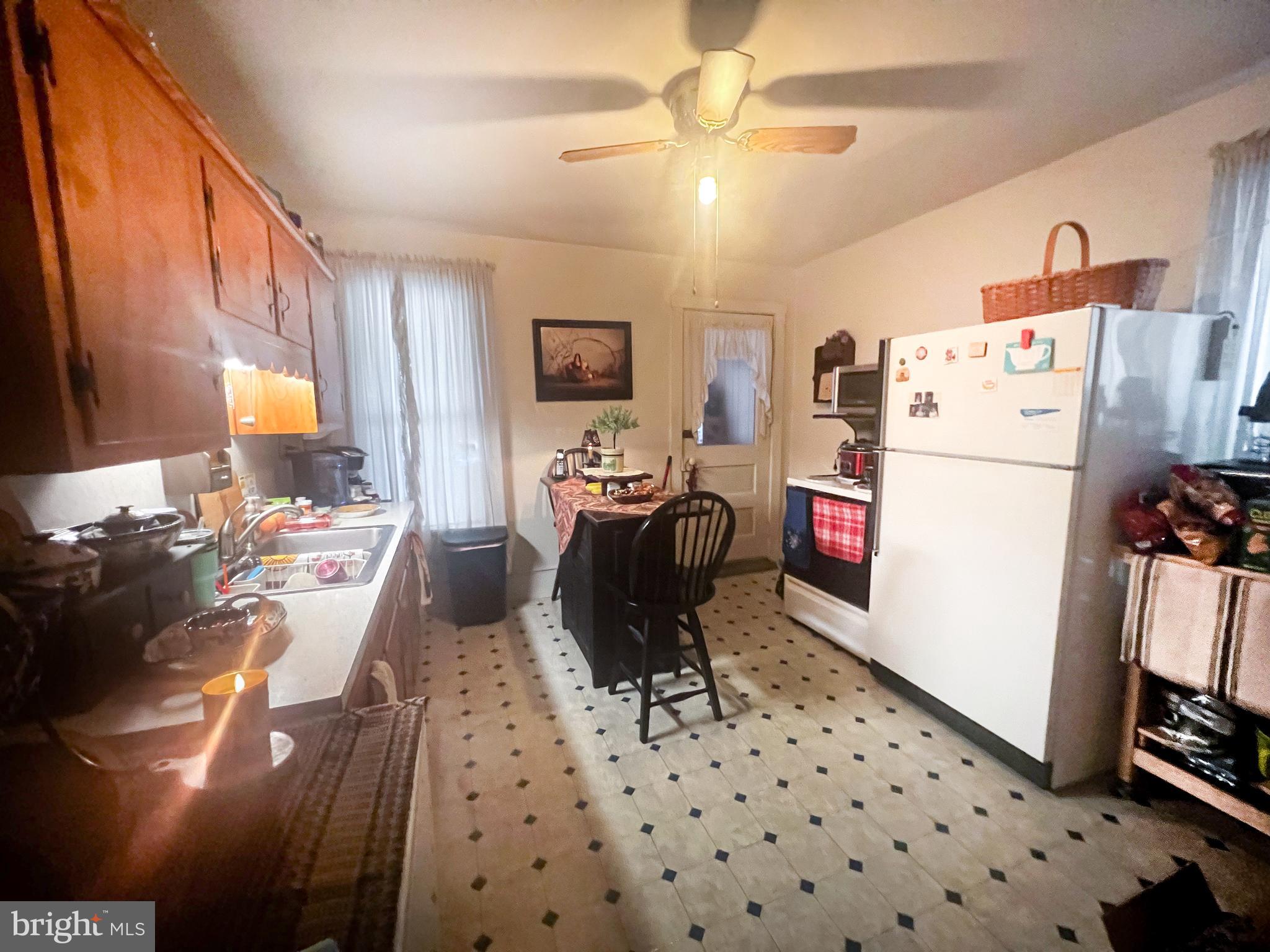 336 South Main Street Burnham, PA 17009 - Photo 18 of 36 a kitchen with a refrigerator a stove top oven a sink a dining table and chairs