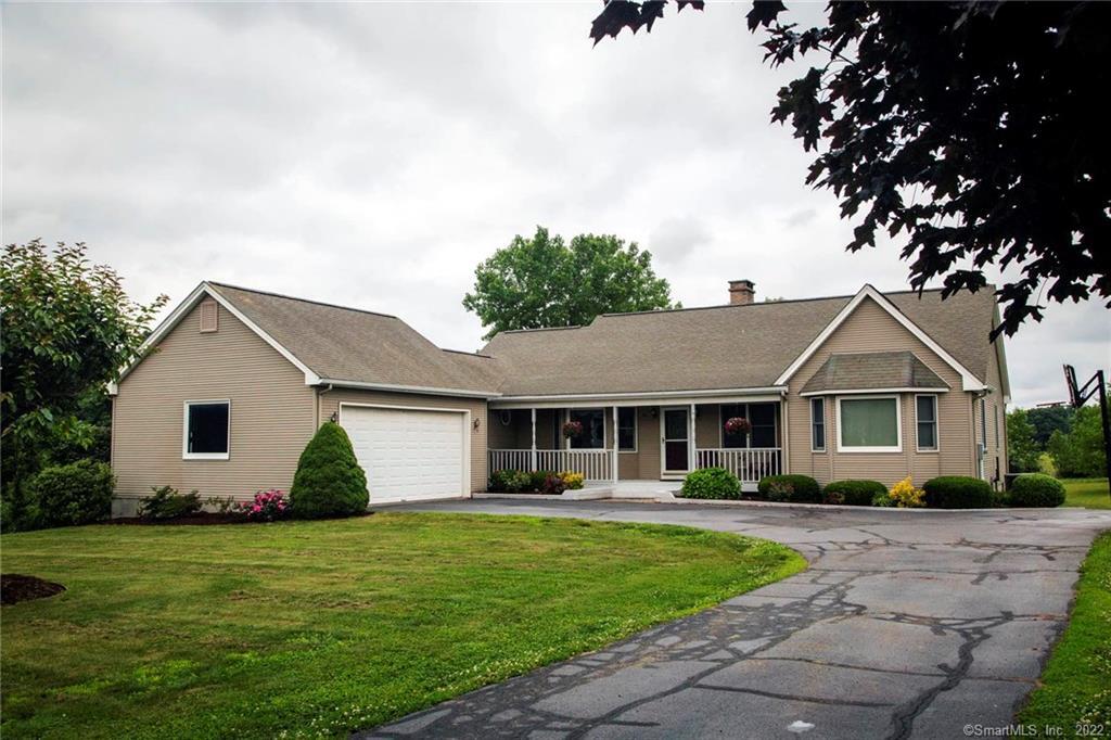 a front view of house with yard and green space