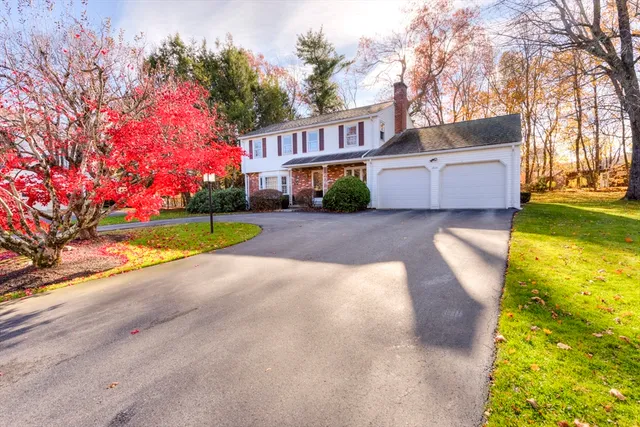 a view of an house with backyard and trees