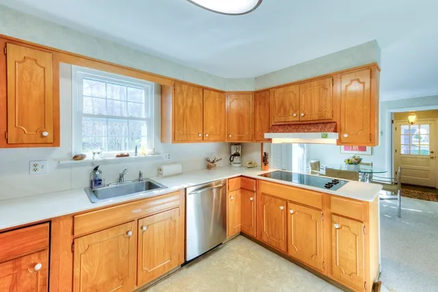 a kitchen with a sink stove top oven and cabinets
