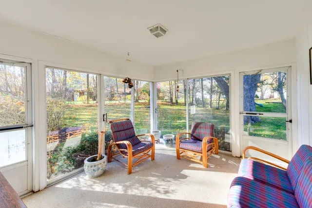 a living room with furniture and floor to ceiling windows