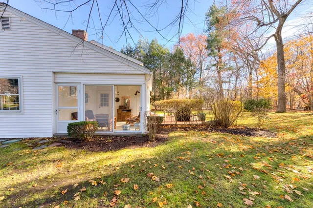 a view of a house with backyard and sitting area