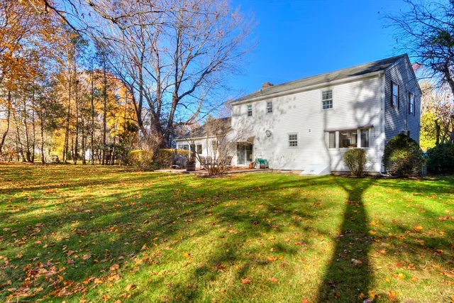 a view of swimming pool with large trees
