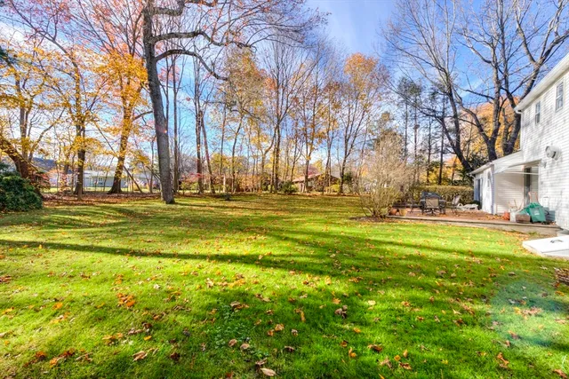a backyard of apartments with large trees