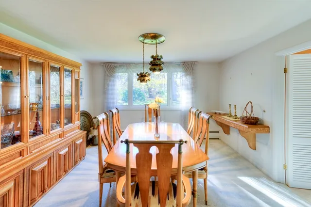 a view of a dining room with furniture a chandelier and wooden floor