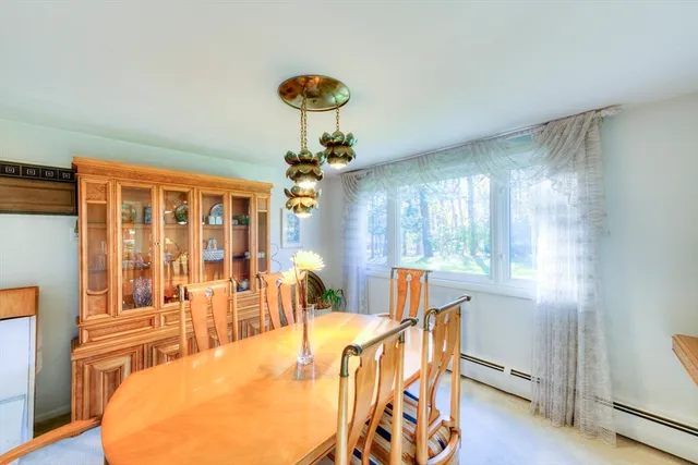 a view of a dining room with furniture a chandelier and wooden floor