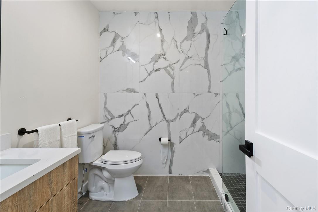 348 Main Street, Unit 3C New Rochelle, NY 10801 - Photo 11 of 14 a white toilet sitting next to a bathroom sink