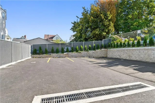 a view of a street with a bench in front of it
