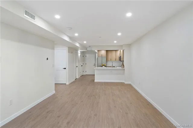 a view of a kitchen with a sink and wooden floor