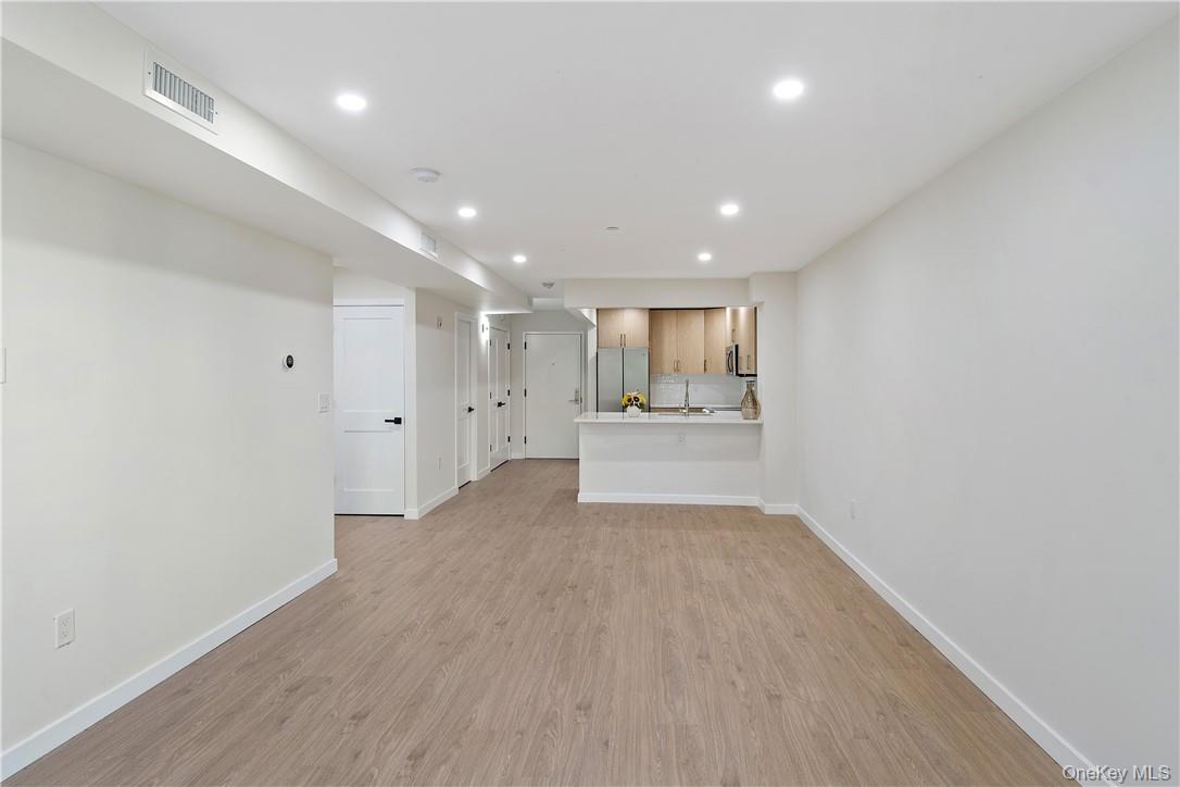 348 Main Street, Unit 3C New Rochelle, NY 10801 - Photo 6 of 14 a view of a kitchen with a sink and wooden floor