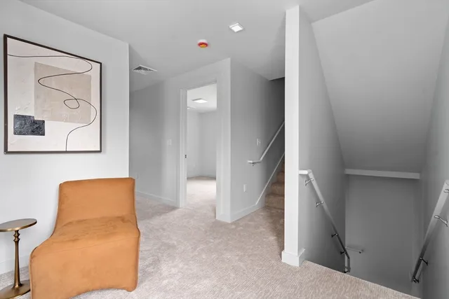 a view of hallway with paintings on the wall