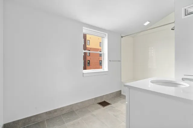 a bathroom with a sink a vanity and a window