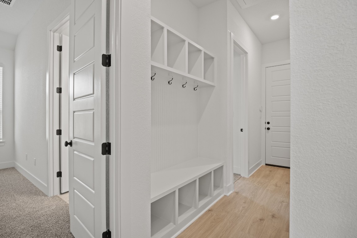 245 Begonia Street Buda, TX 78610 - Photo 10 of 21 a view of a hallway with white walls