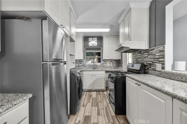 a kitchen with a sink stove and refrigerator