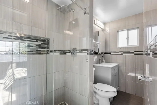 a bathroom with a sink a toilet and a shower