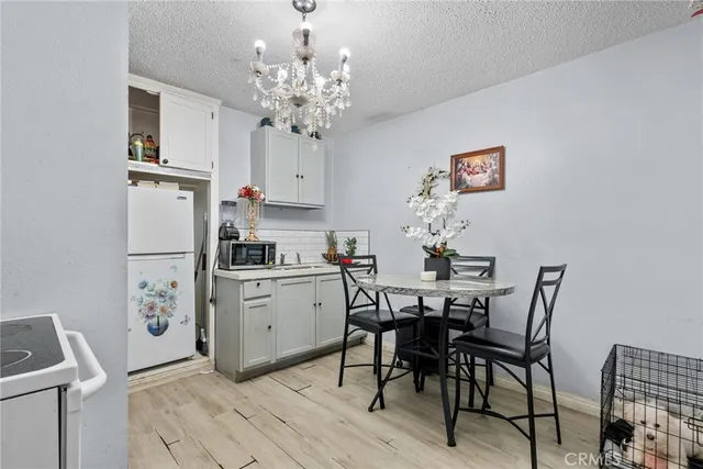 a view of kitchen and dining area with a sink