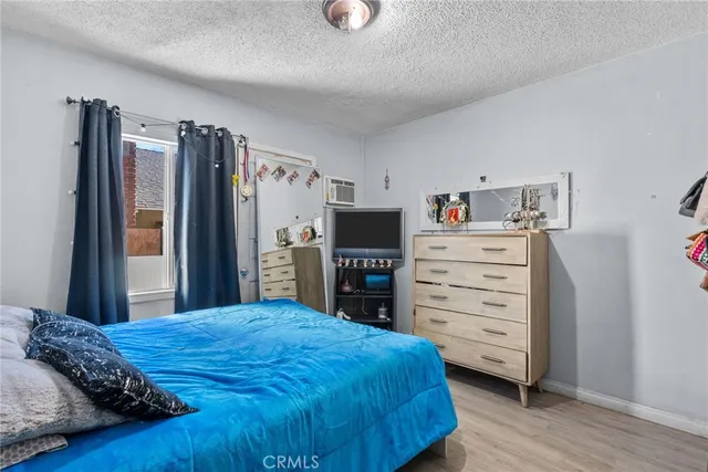 a bedroom with a bed and a television