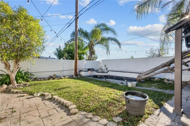 a view of a backyard with plants and patio