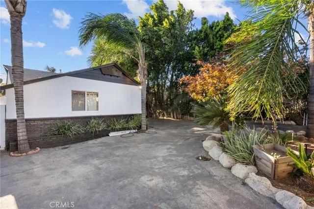 a view of a house with a tree in the background