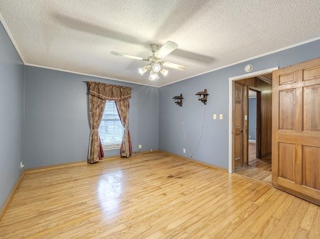 660 Hinton Road Counce, TN 38326 - Photo 22 of 40 Room featuring wood-finish flooring, a ceiling fan, and a wood-paneled door