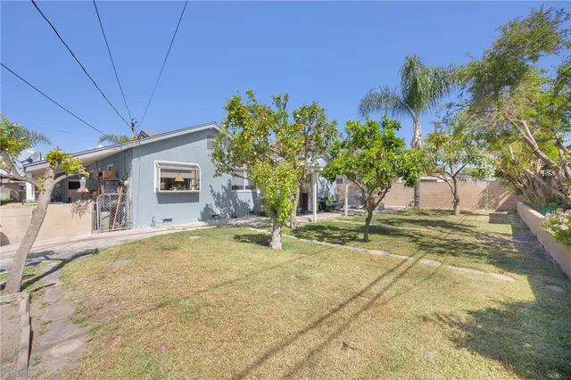 a view of a house with a backyard and a garage