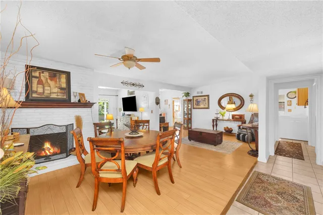 a view of a livingroom with furniture a fireplace a flat screen tv and a fireplace