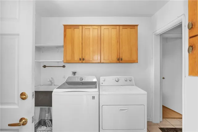 a bathroom with a sink a washer and dryer