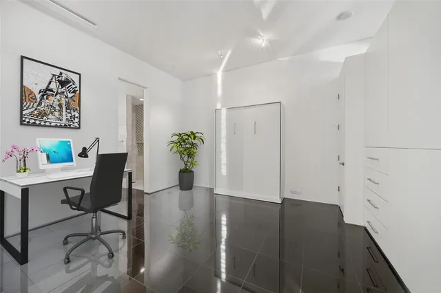 a view of a workspace with furniture and wooden floor