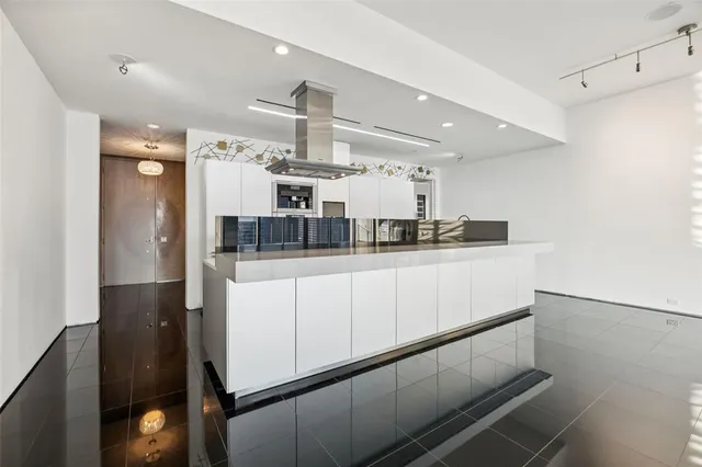 a kitchen with stainless steel appliances a refrigerator and cabinets