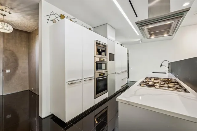 a kitchen with a refrigerator and a stove