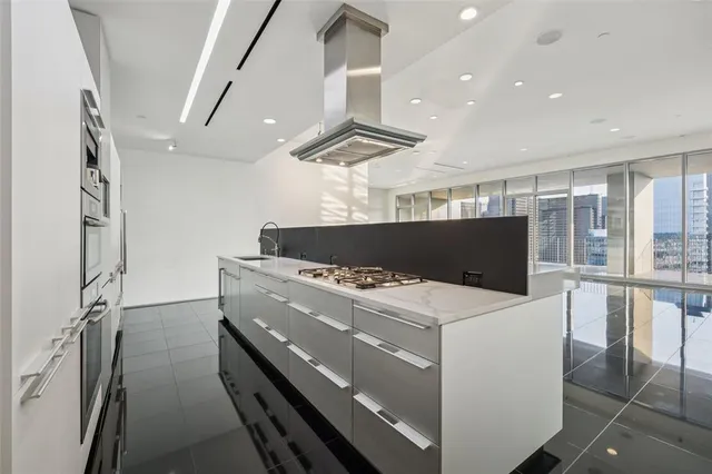 a large white kitchen with a large window